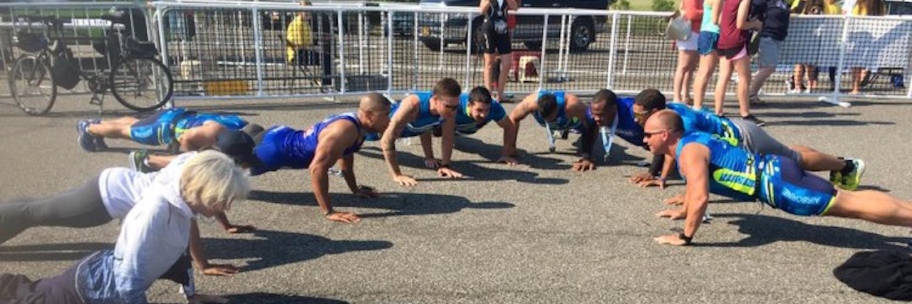 a group of runner doing pushups