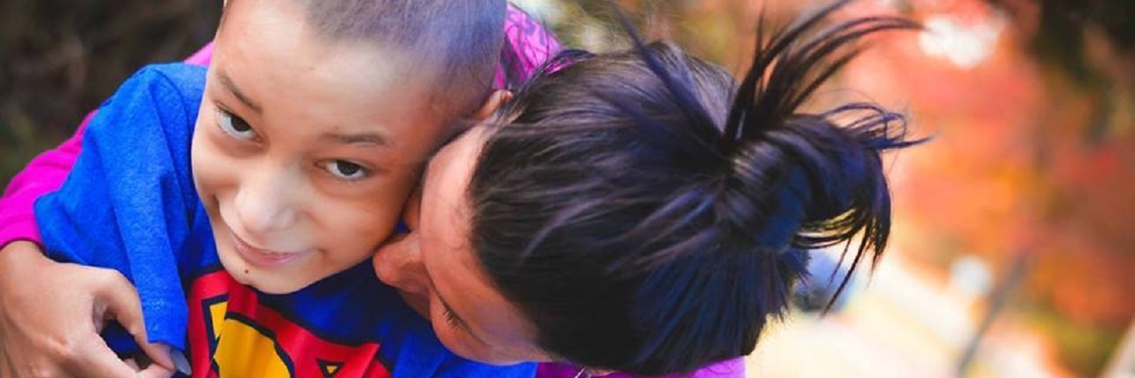 Photographer Steph Smith Gives Free Photo Shoots to Special Needs Kids Stephanie Smith hugs one of her photo subjects.