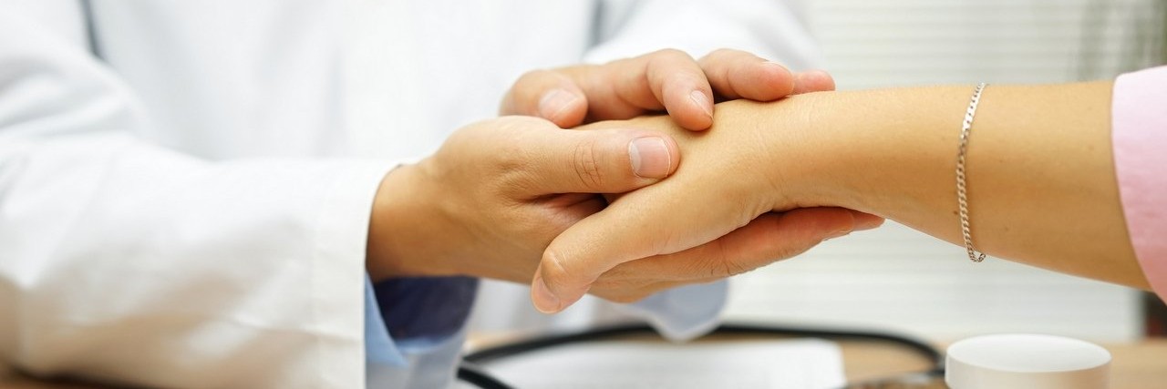 doctor holding patient’s hand