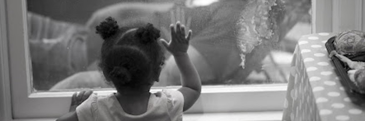 Why I've Stayed With My Spouse With Bipolar Disorder and PTSD Little girl looking through the glass at her dad