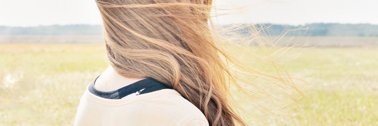 Trying to Find My Identity After a Chronic Pain Diagnosis young woman standing in field