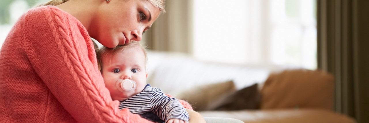 Asking 'What If': When Postpartum Anxiety Causes Constant Worry Sad mom holds her baby