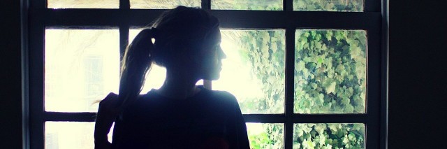 woman standing by window