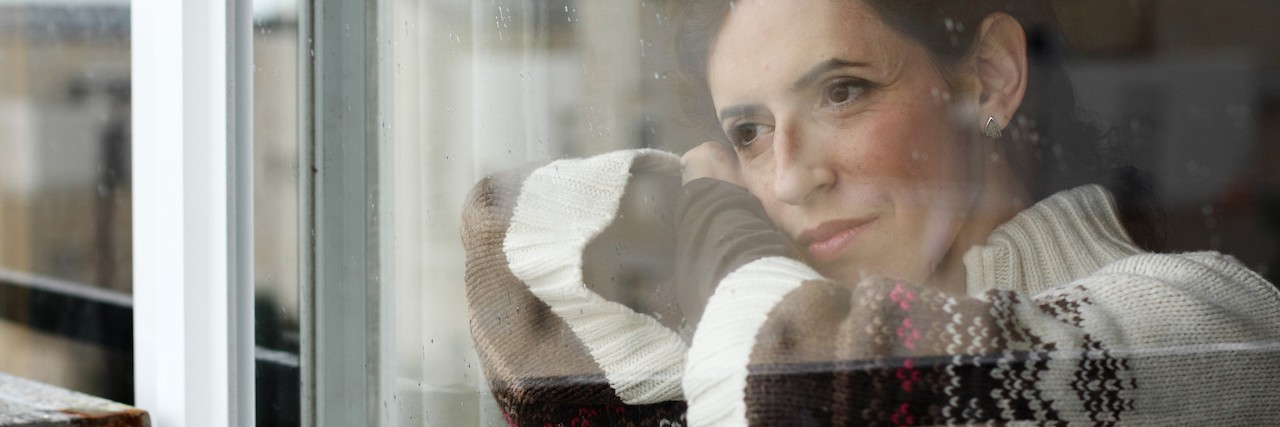 Fear of Having Children When You Have Emetophobia A sad woman looks out of a window