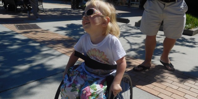 What I Miss When I Leave My Medically Fragile Daughter to Work Outside the Home Heidi, a little girl with spinal muscular atrophy pushing her wheelchair.