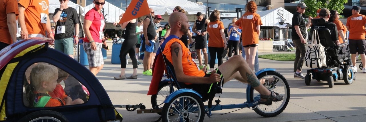 Derek Hogg participating in the Strike Out ALS 5K race with his children