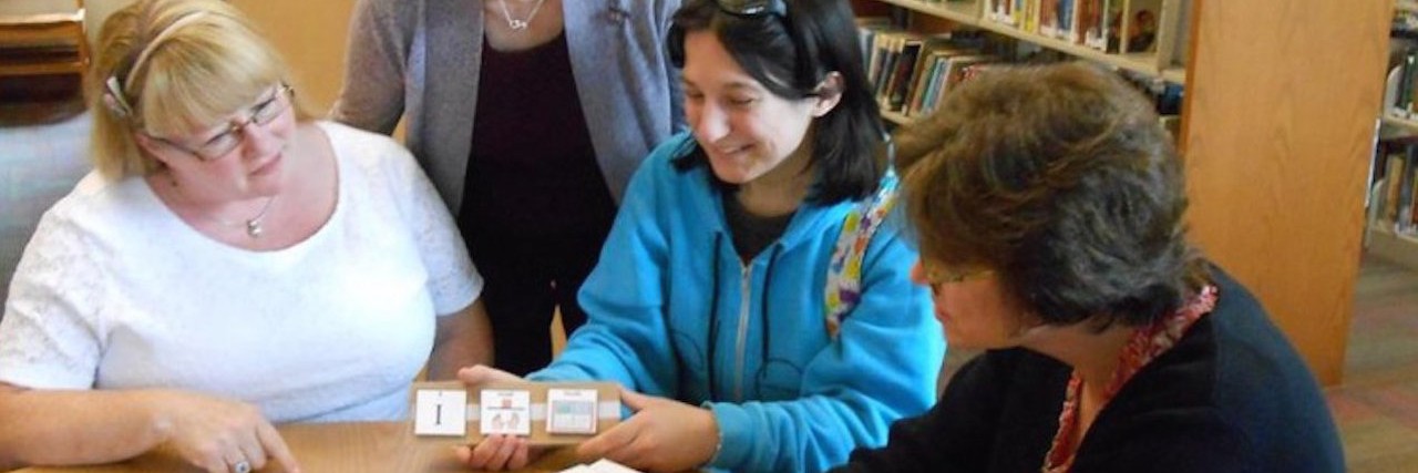 What My Library Means to Me as a Person on the Autism Spectrum Erin Clemens showing librarians a picture communication book