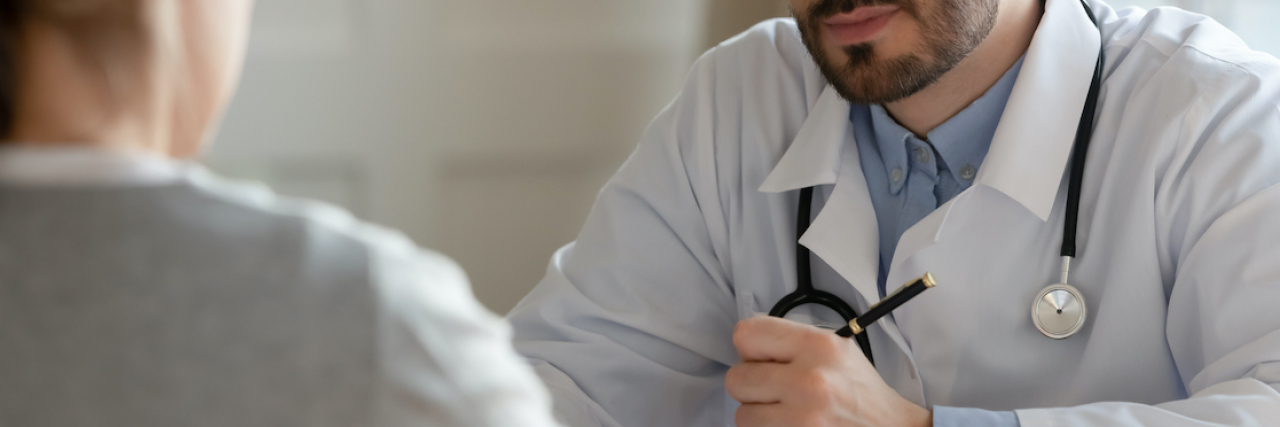 When a Doctor Dismissed My Pain Because of My Weight and Anxiety Rear view of doctor speaking with unrecognizable patient