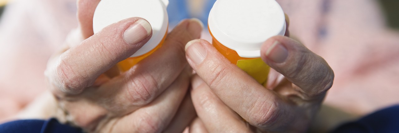 To the People Who Wonder if Medication Helps With OCD Woman holding medicine bottles