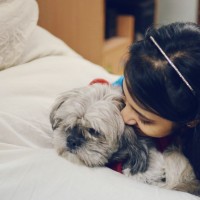 girl giving her dog a kiss