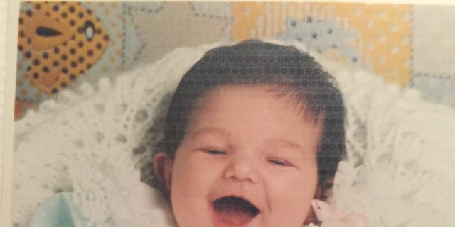cami smiling as a baby