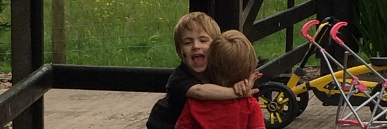 Claire's sons hugging outside