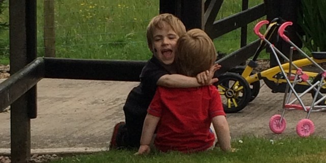 Claire's sons hugging outside
