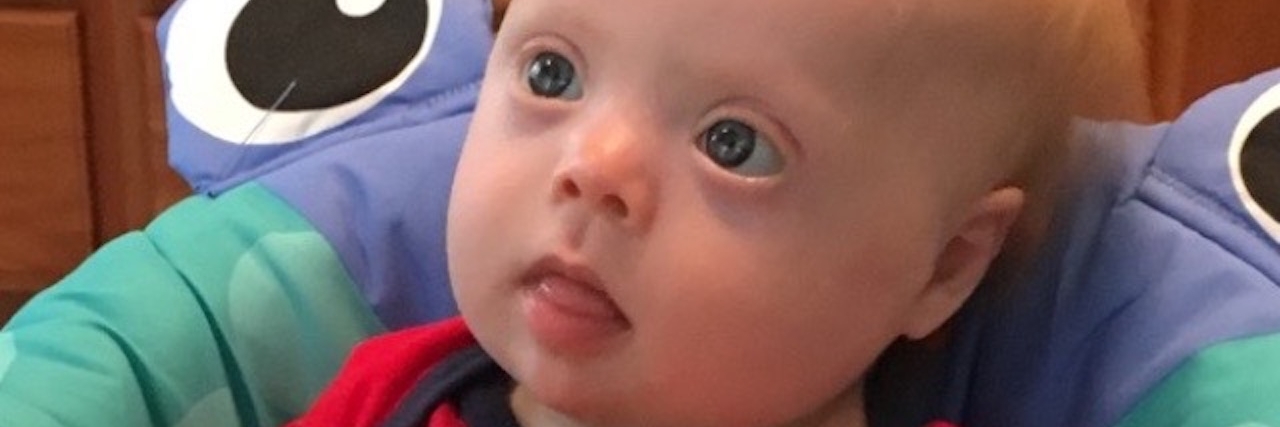 The R-Word Is Offensive, Even When There Is No Ill Intent baby with down syndrome in a walker
