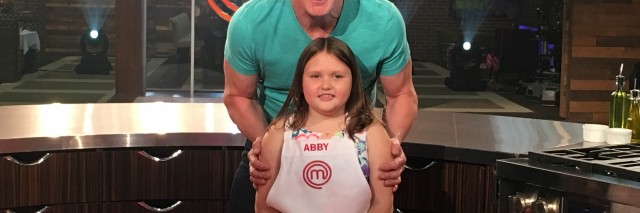 Gordon Ramsay standing behind Abby on the show's set.
