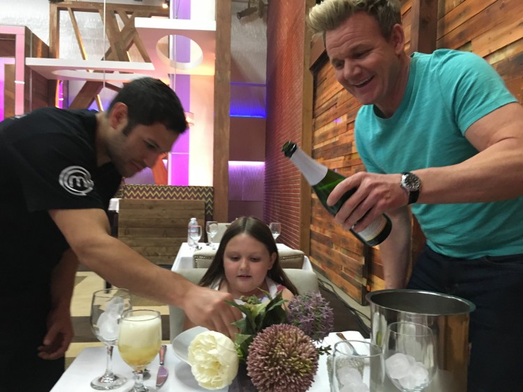 Gordon Ramsay and his staff serving Abby a meal.