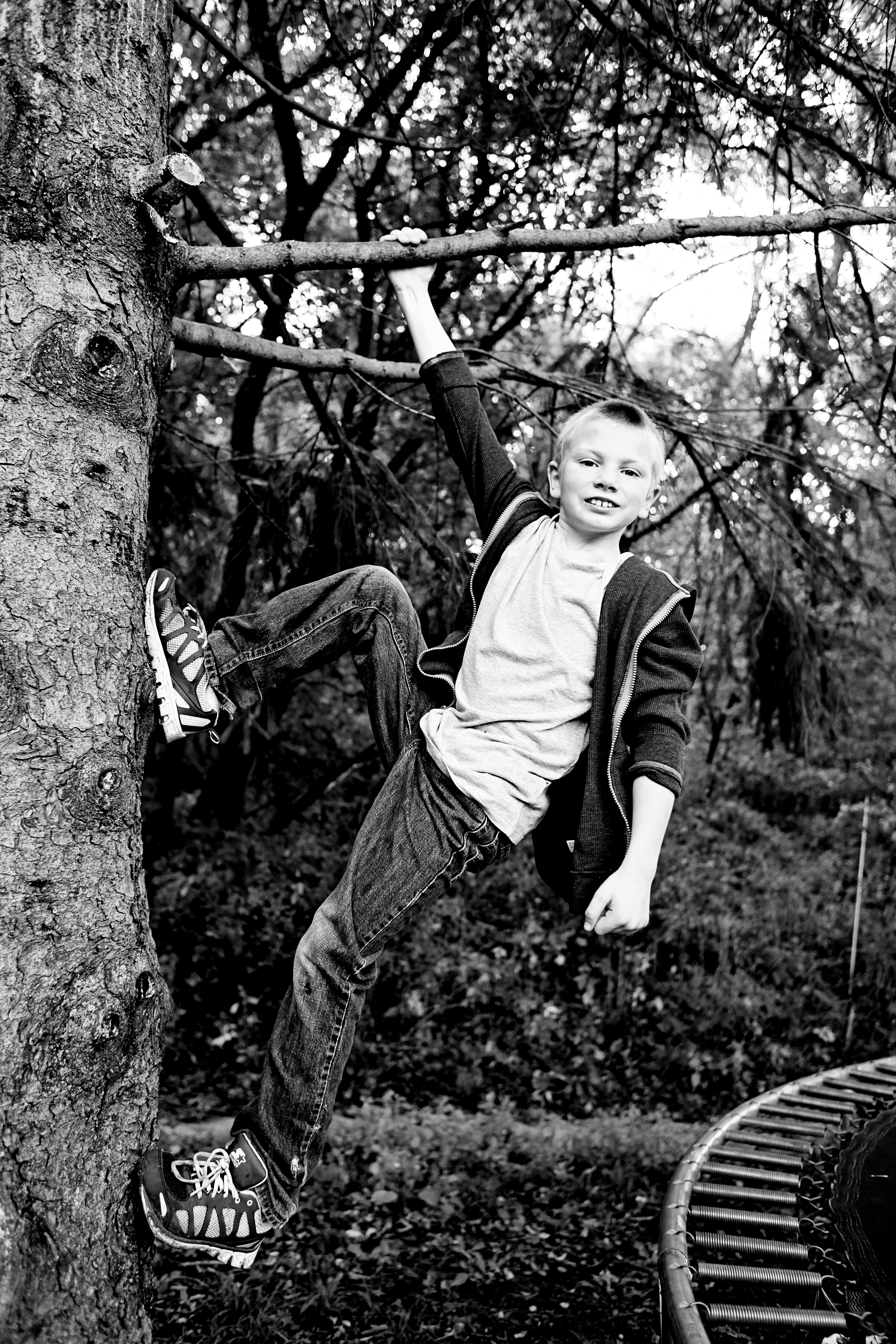 boy with autism climbing a tree