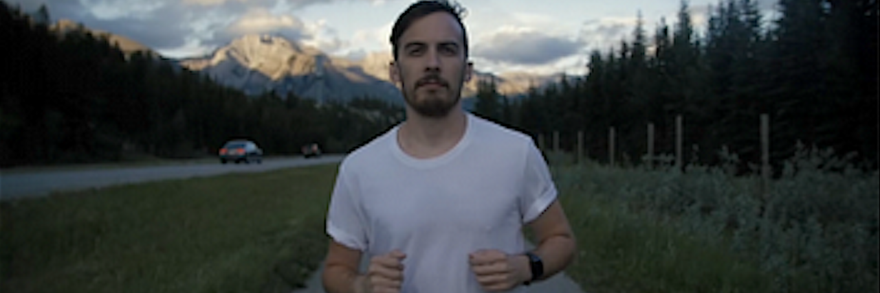 How I Turned My Depression From a Weakness Into a Strength A man running on a trail with the forest behind him