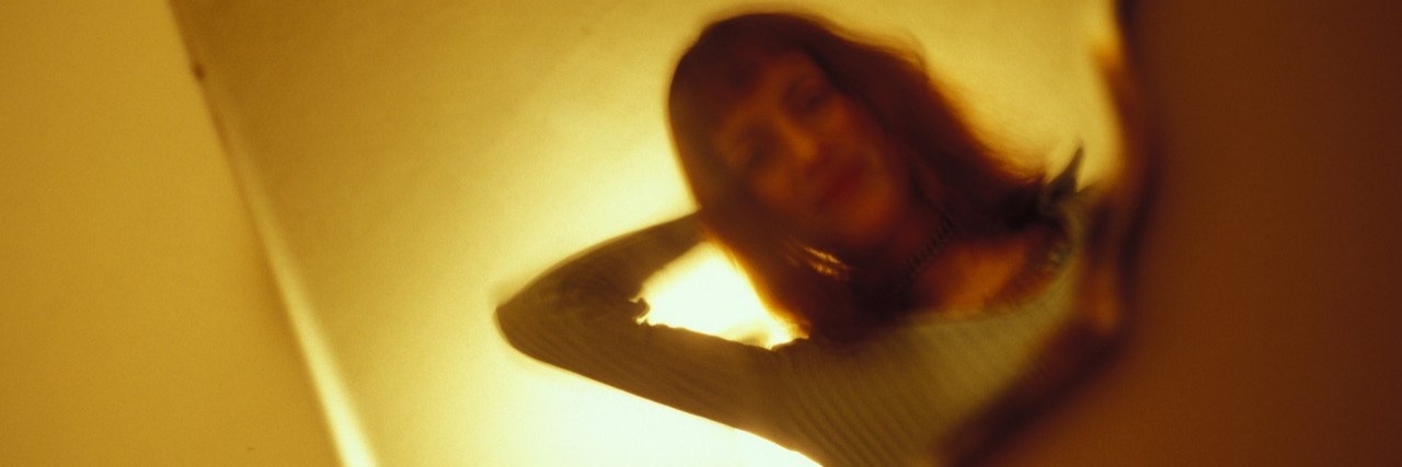 Grief: Seeing My Father’s Eyes When I Look in a Mirror Woman in a mirror