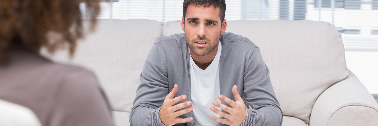 man talks to therapist in counseling session
