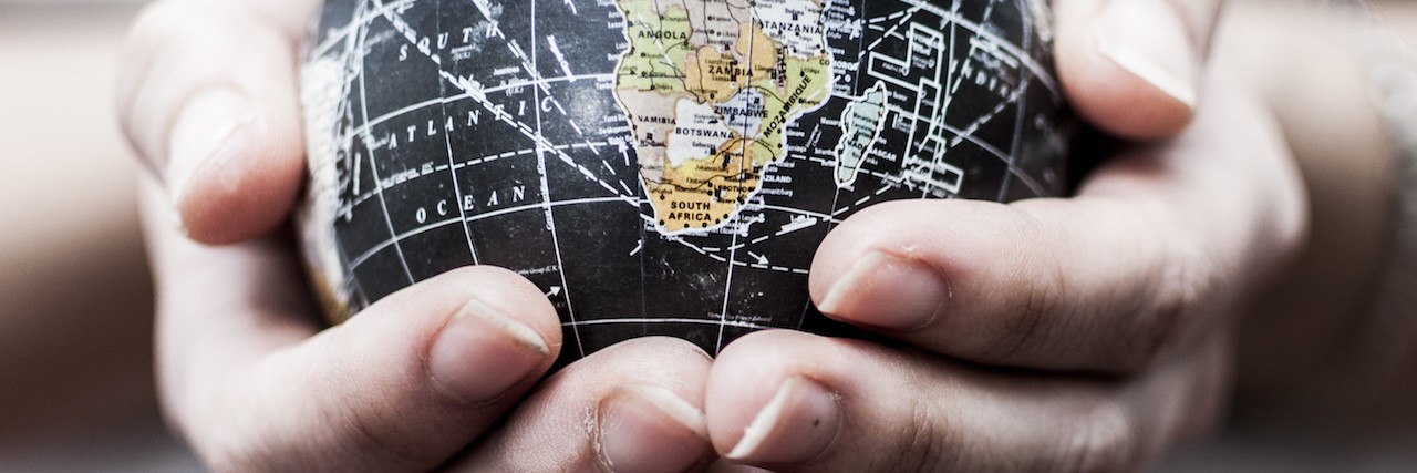 How to Manage Anxiety During Violent Times Female hands holding a globe