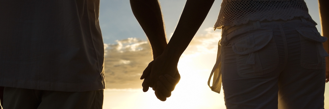 How to Respond Someone Who's Loved One Has an Addiction Couple holding hands with beach in the background