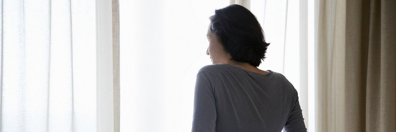 What I Want You to Know About Crohn’s Disease Woman looking through window