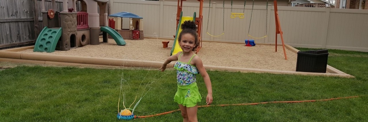 Reflections After My Child's Hospital Stay Heather's daughter Maya playing in the sprinkler