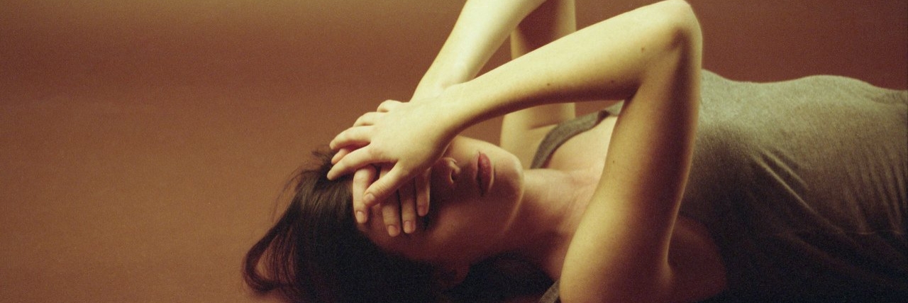 What Gets Me Through My Migraines woman coping with a migraine headache