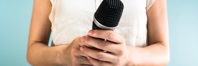 Upclose shot of a woman holding microphone