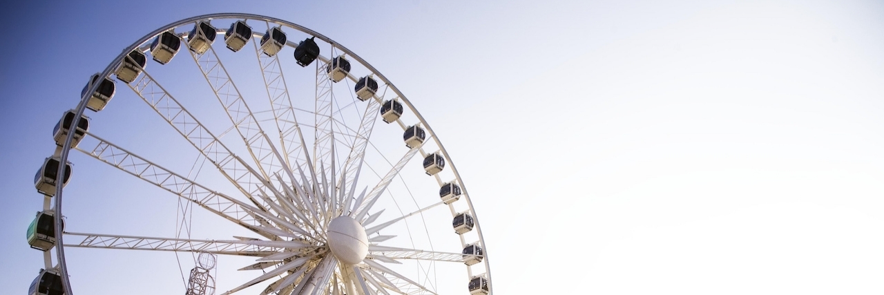 Recovering from Childhood Trauma: Feeling Beautifully Broken Spinning ferris wheel on a sunny day