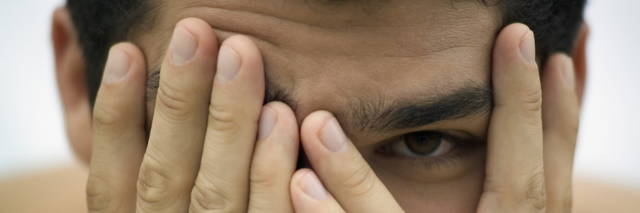 Opening Up to People After Having Hidden Depression Man hides face between hands
