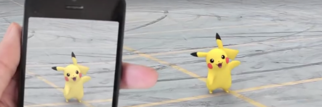 How Pokemon Go Helps Someone With an Eating Disorder and Autism Hand holding phone showing them playing Pokemon Go, and finding Pikachu