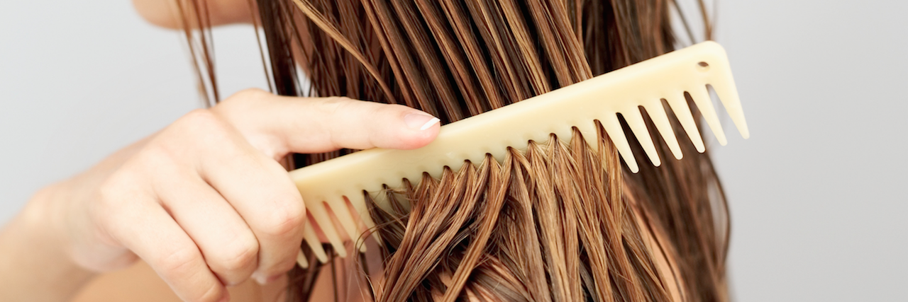 My Trichotillomania Is Not Just a 'Bad Habit' girl running a comb through her wet hair