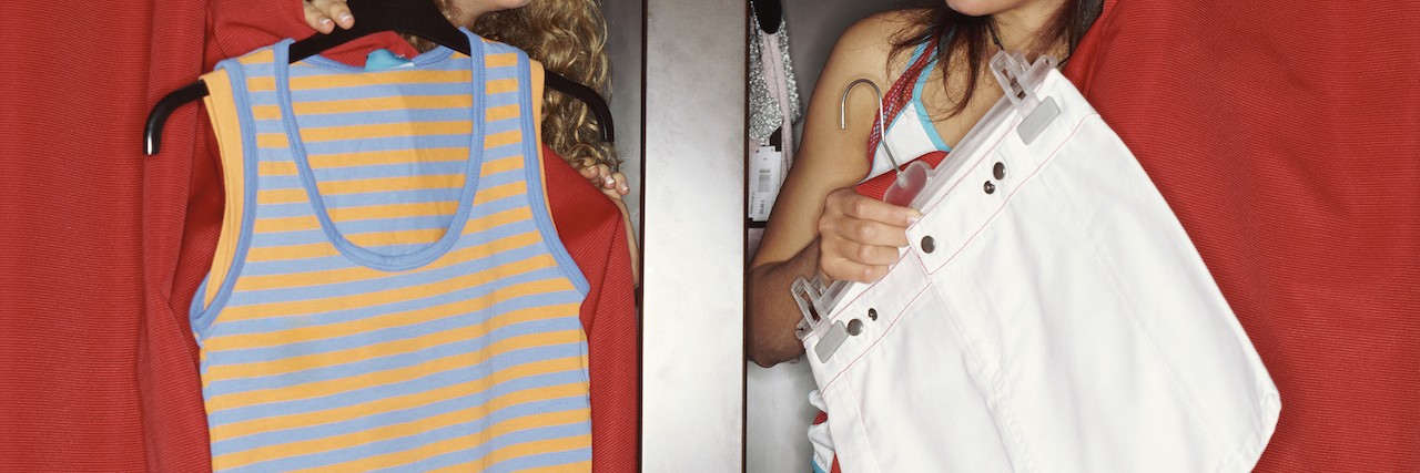 Mom Responds to Girls in Target Who Wanted to Be Skinny Two girls poke their heads out of their dressing rooms to show each other clothes