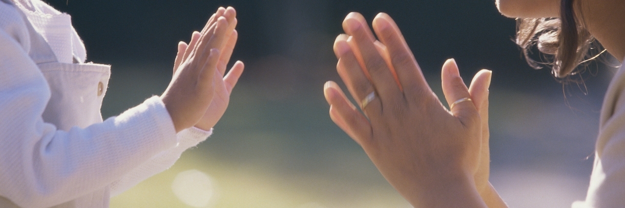 What Mental Illness Teaches You About Parenthood Mom and daughter playing a hand game