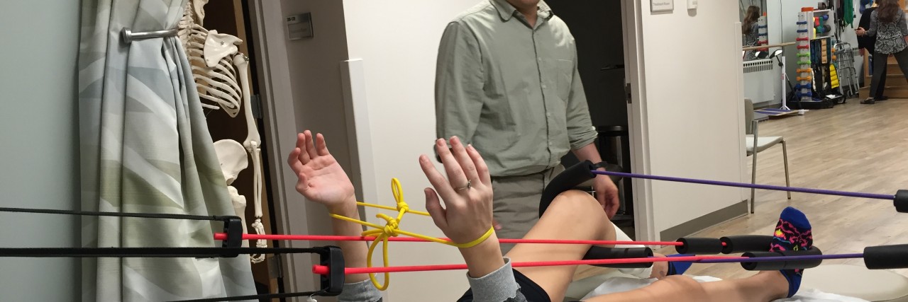 How to Choose a Doctor for Autoimmune Disease woman lying on exam table doing physical therapy