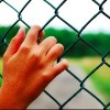 hands on a fence