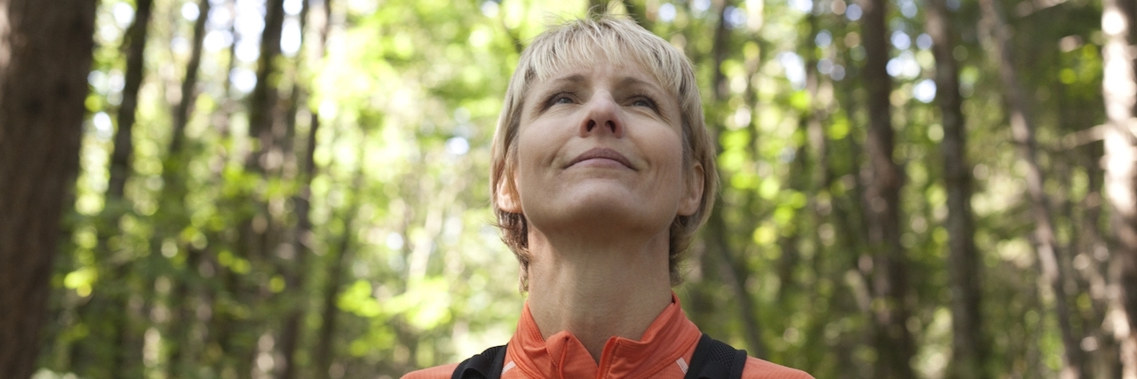 When Joy Returns After a Bout of Depression Woman looking at sky during hike in forest