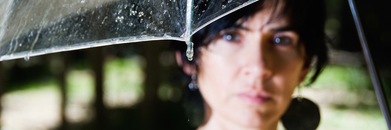 A Letter to Anyone Struggling With Mental Illness A woman standing under an umbrella