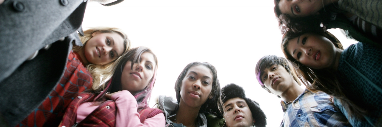 Low angle view of friends looking at camera.