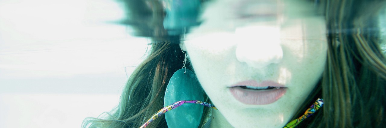 lower half of woman's face underwater