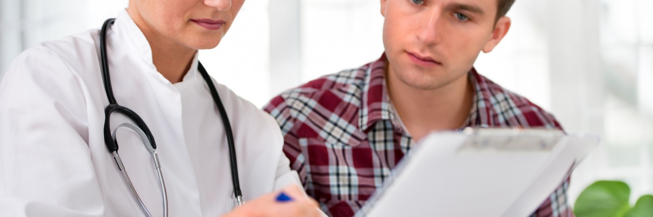 Receiving a Late Diagnosis With Kallmann Syndrome doctor talking to her male patient at office