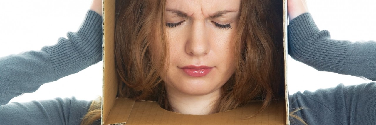 Misconceptions About My Agoraphobia conceptual portrait of a woman's head hidden in a cardboard box