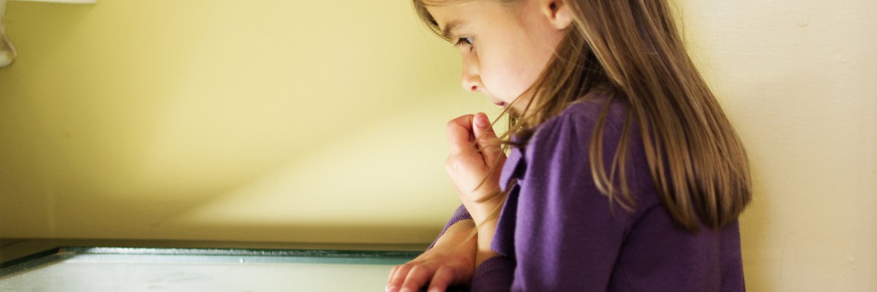 Special Needs Parenting Tools: Hope, Positivity, Perseverance & Faith A young girl peers into the lit display cabinet in a museum