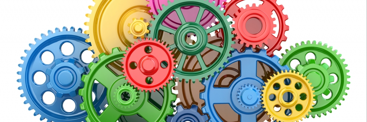 What Autism Gives and Takes Away From Me Color gears on white isolated background.