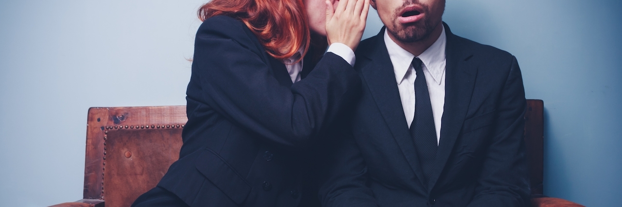 Lies Anxiety Tells You and How to Combat Them Young woman is gossiping to her male coworker who looks pretty astonished