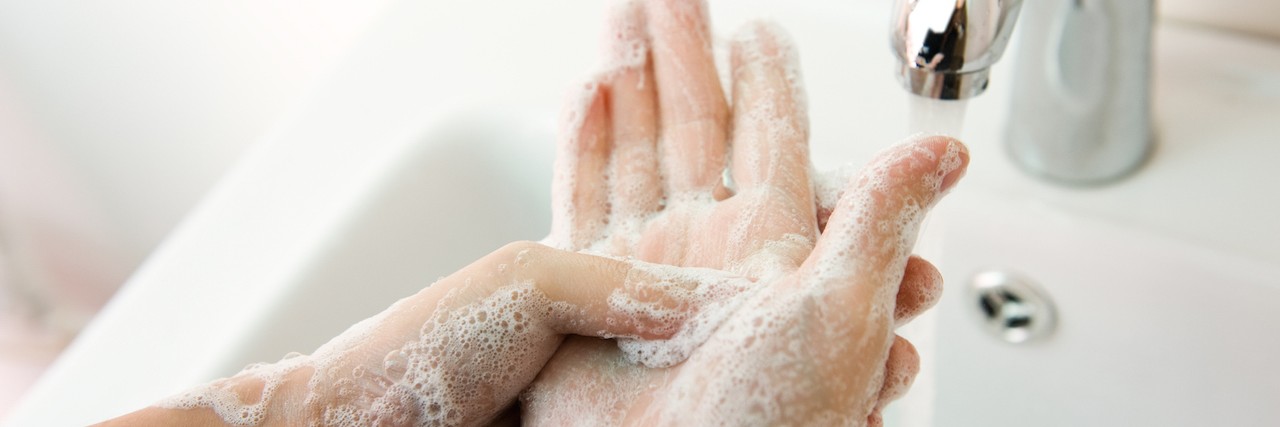 a woman washing her hands