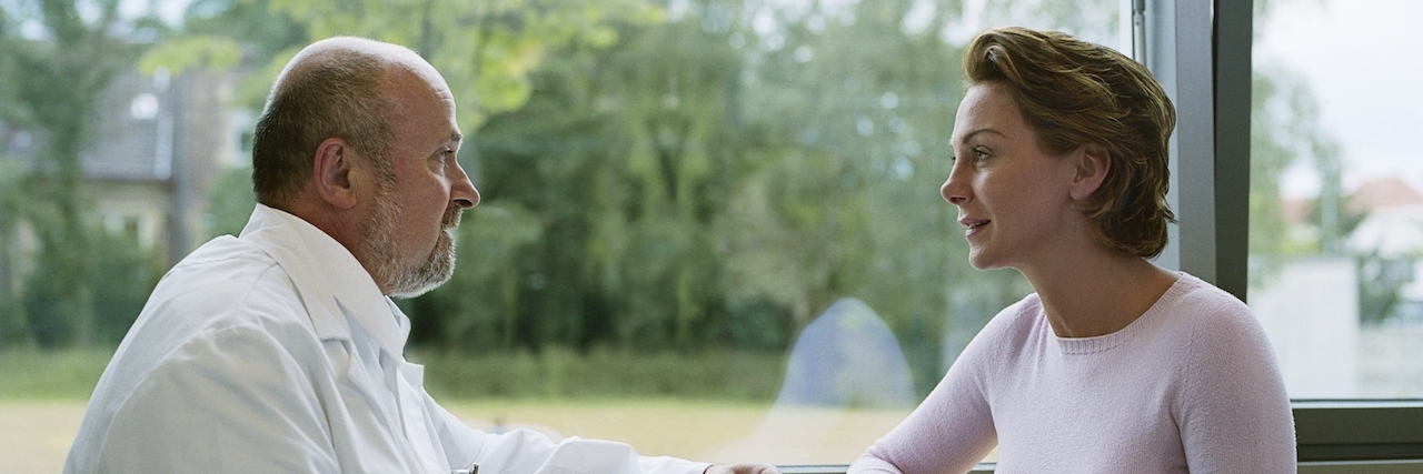 When a Doctor Helped Me Accept My Postnatal Depression Male doctor sitting with female patient by window, side view