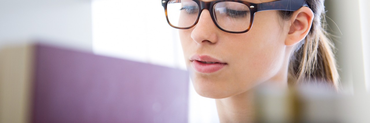 Lessons From Life With OCD Woman looking through bookcase